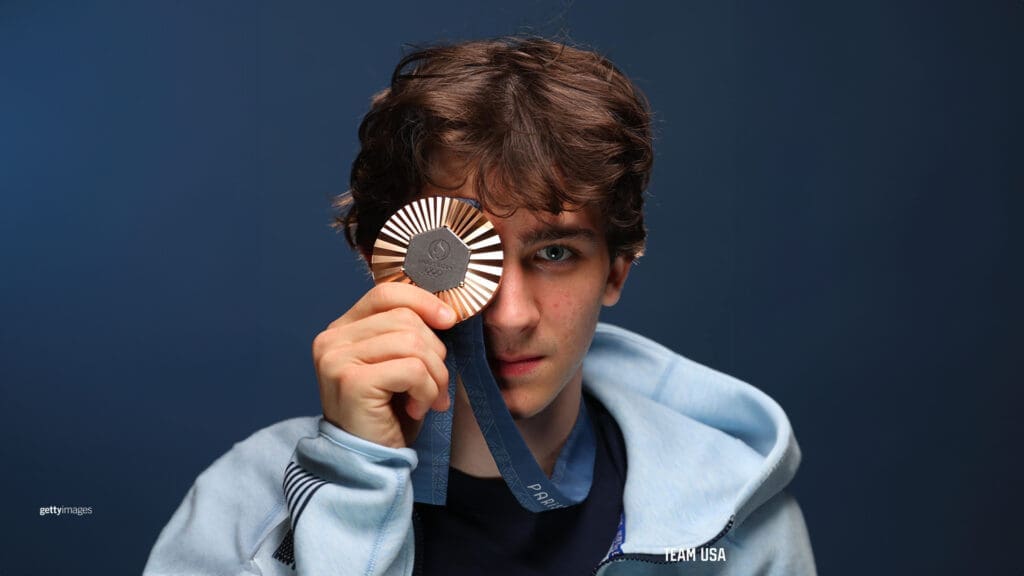 Image of Sam Watson holding his bronze medal