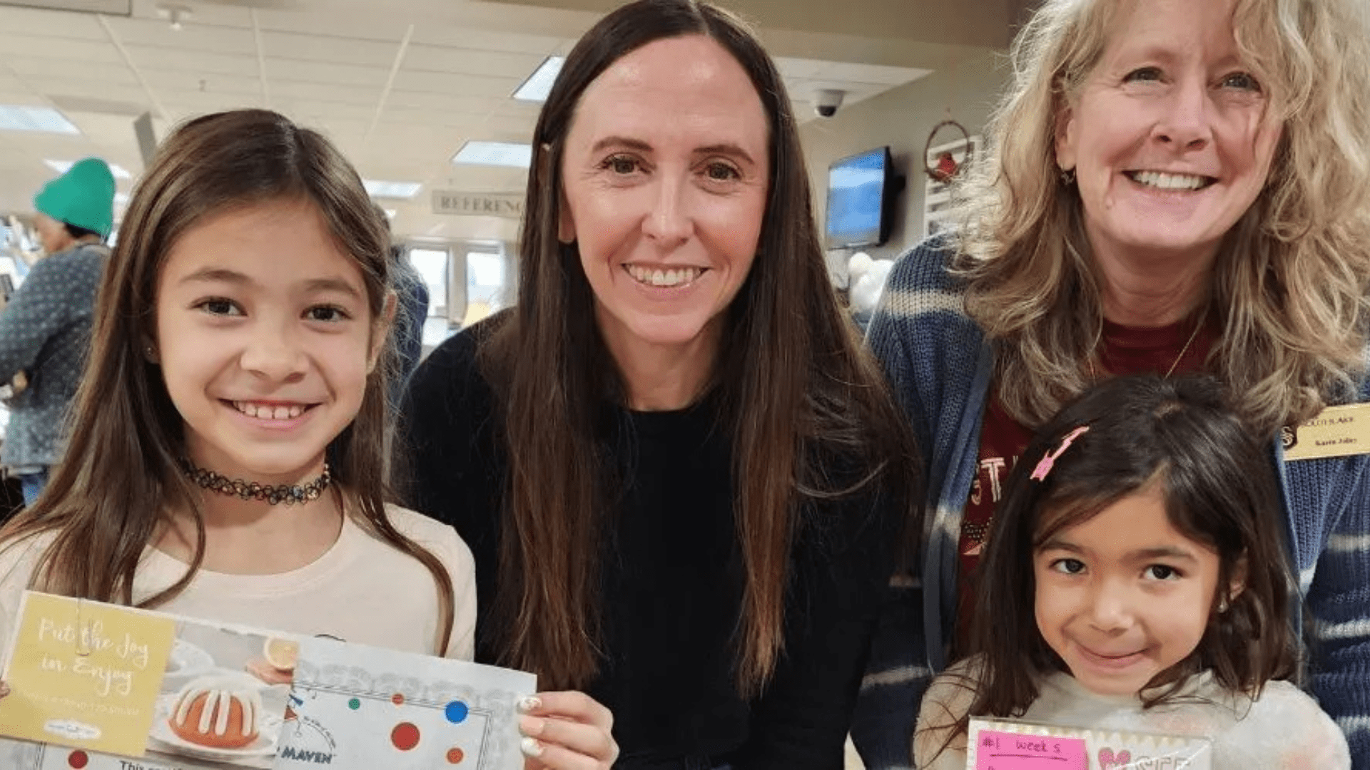 Image shows library staff with 2023 Winter Reading Winnners